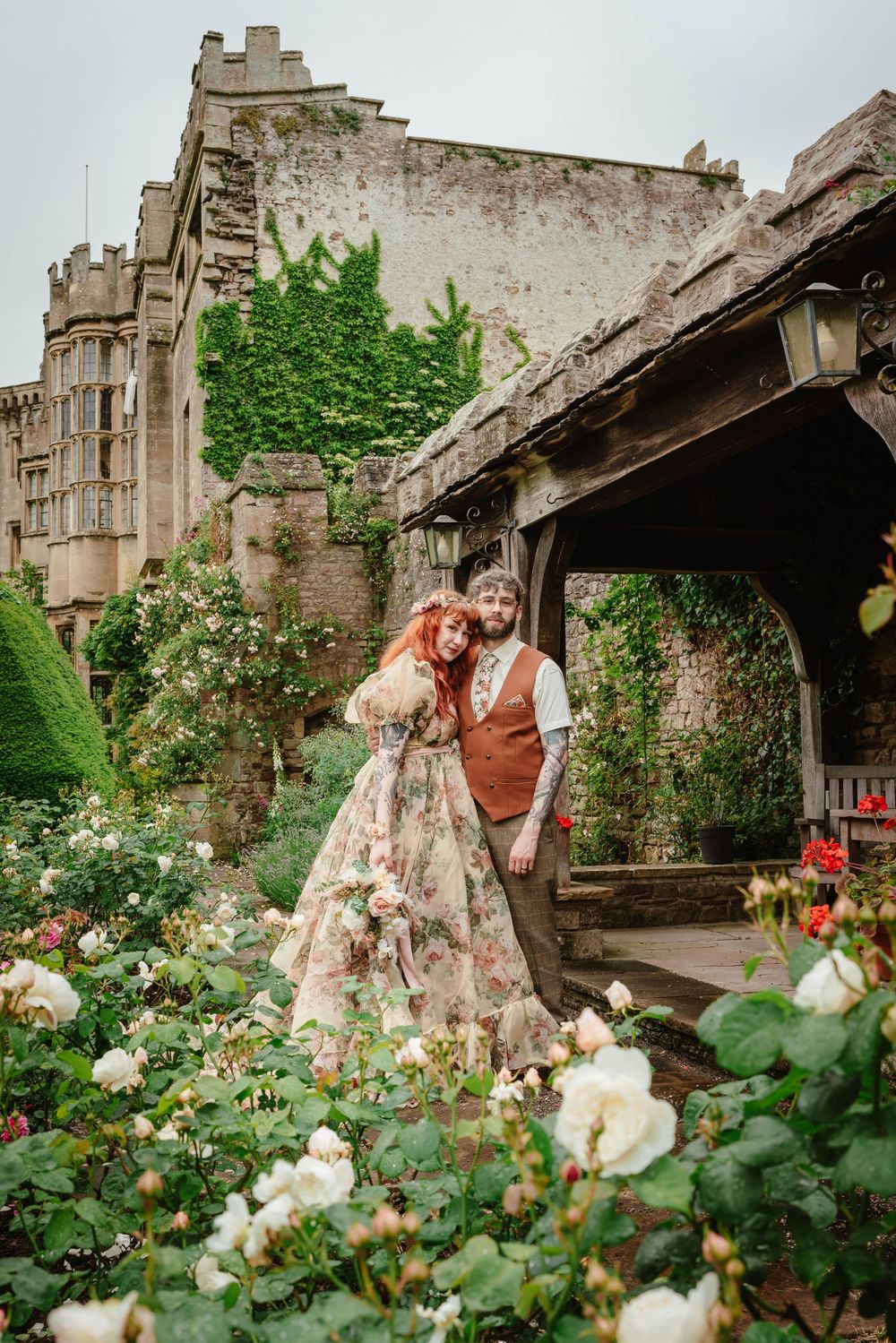 Bride and groom portraits at Thornbury Castle gloucestershire couple posing in the flowers