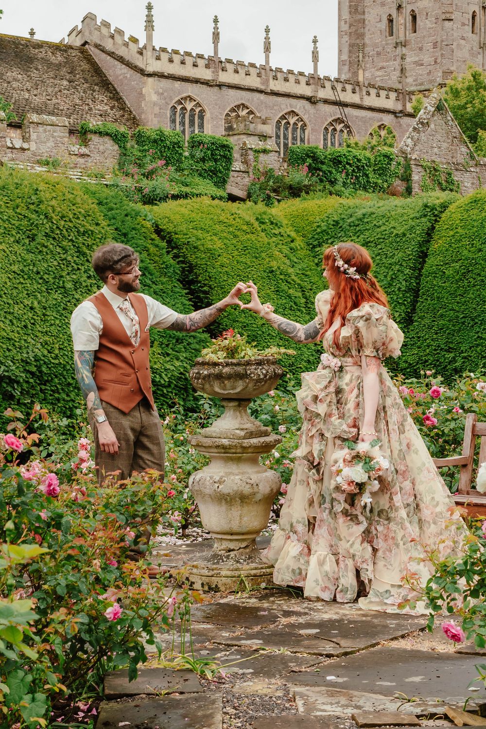 Bride and groom portraits at Thornbury Castle gloucestershire couple making a heart with their hands