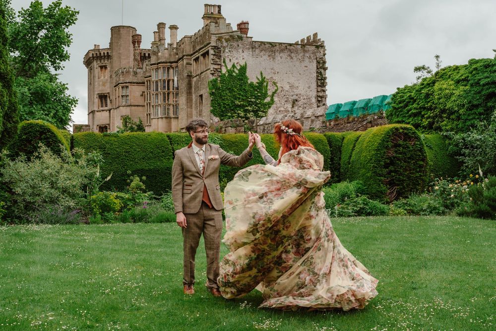 Bride and groom portraits at Thornbury Castle gloucestershire dancing in the garden