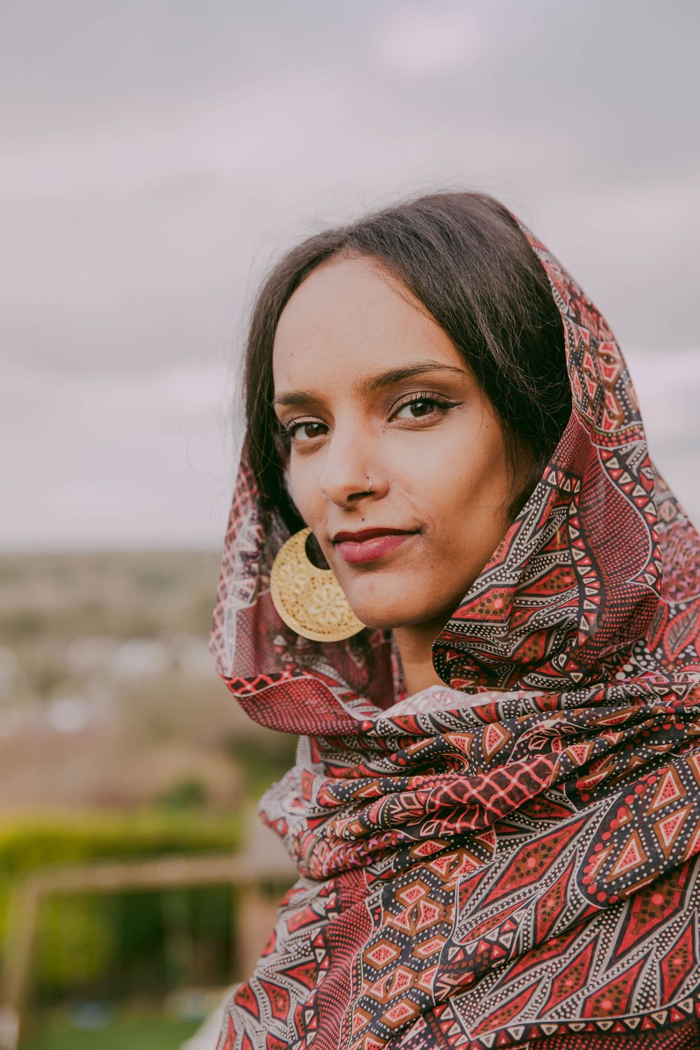 Portrait of Sudanese/Welsh Model, wearing silk Toub in NORTH WALES, designed by HIMA RAHAMA. Jewellery by KUKU Jewellery