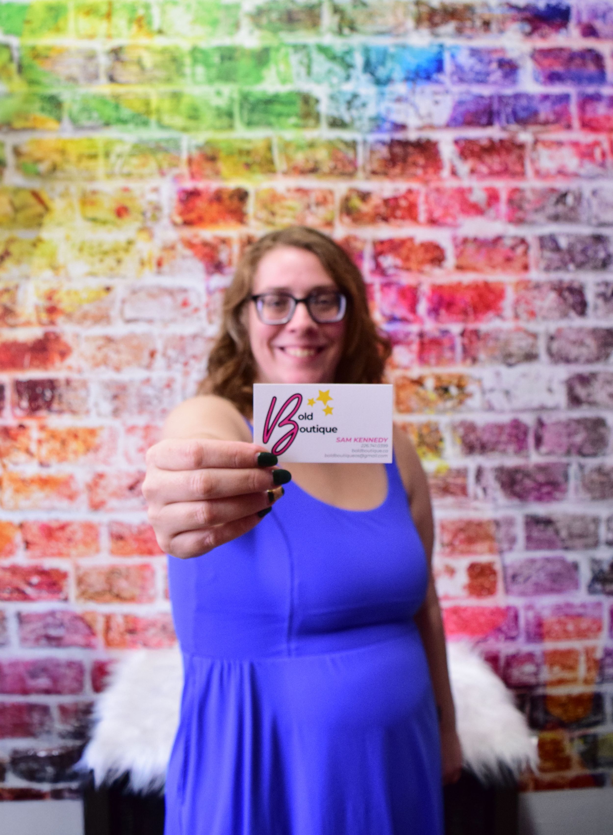 A series of photos against a colorful rainbow brick wall background showing someone in a bright blue sleeveless top.