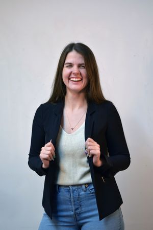 A series of photos showing someone in a black blazer and jeans posing expressively against a light background.