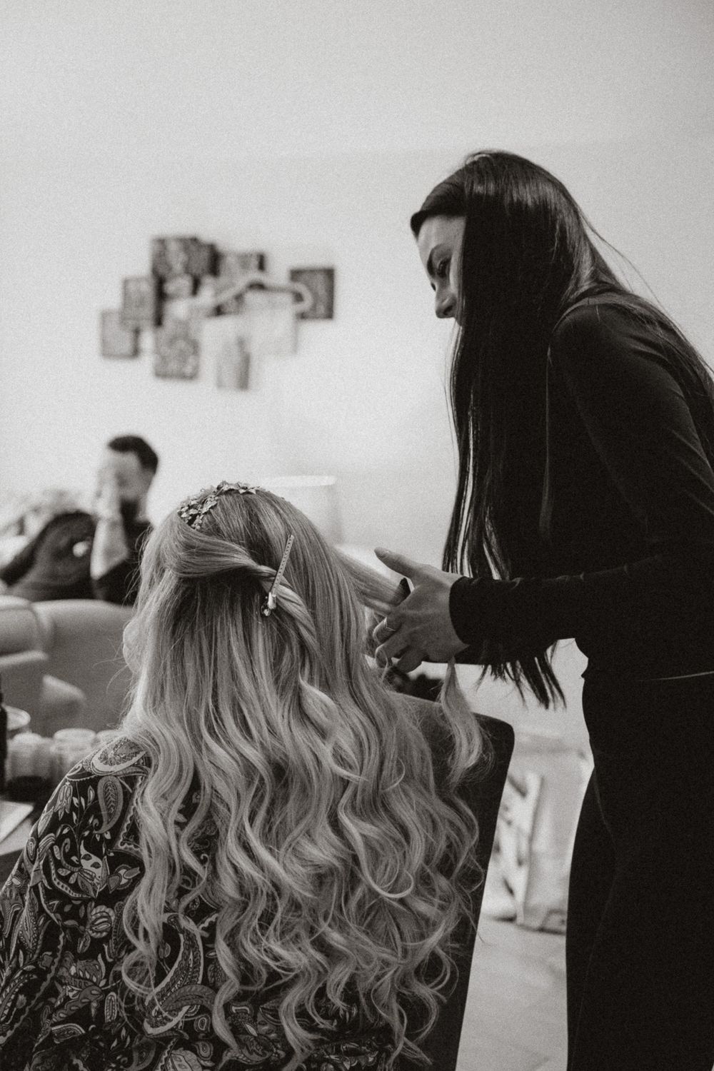 Black and white photo series showing hair styling preparation with long wavy blonde hair being worked on.