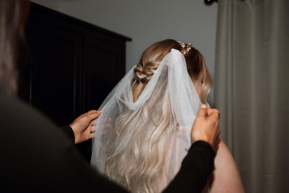 A touching first look moment between a bride and groom as they embrace before their wedding ceremony.