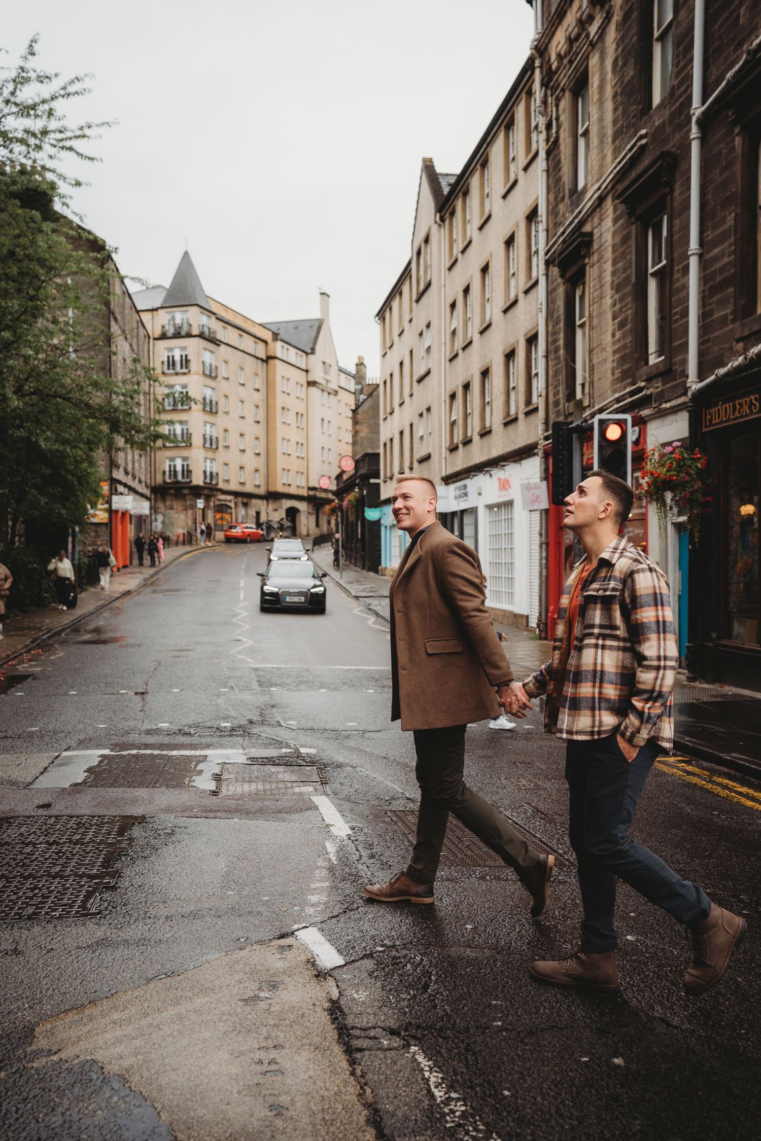 A series of urban street scenes in Edinburgh showing stone buildings and pedestrians walking on a rainy day.