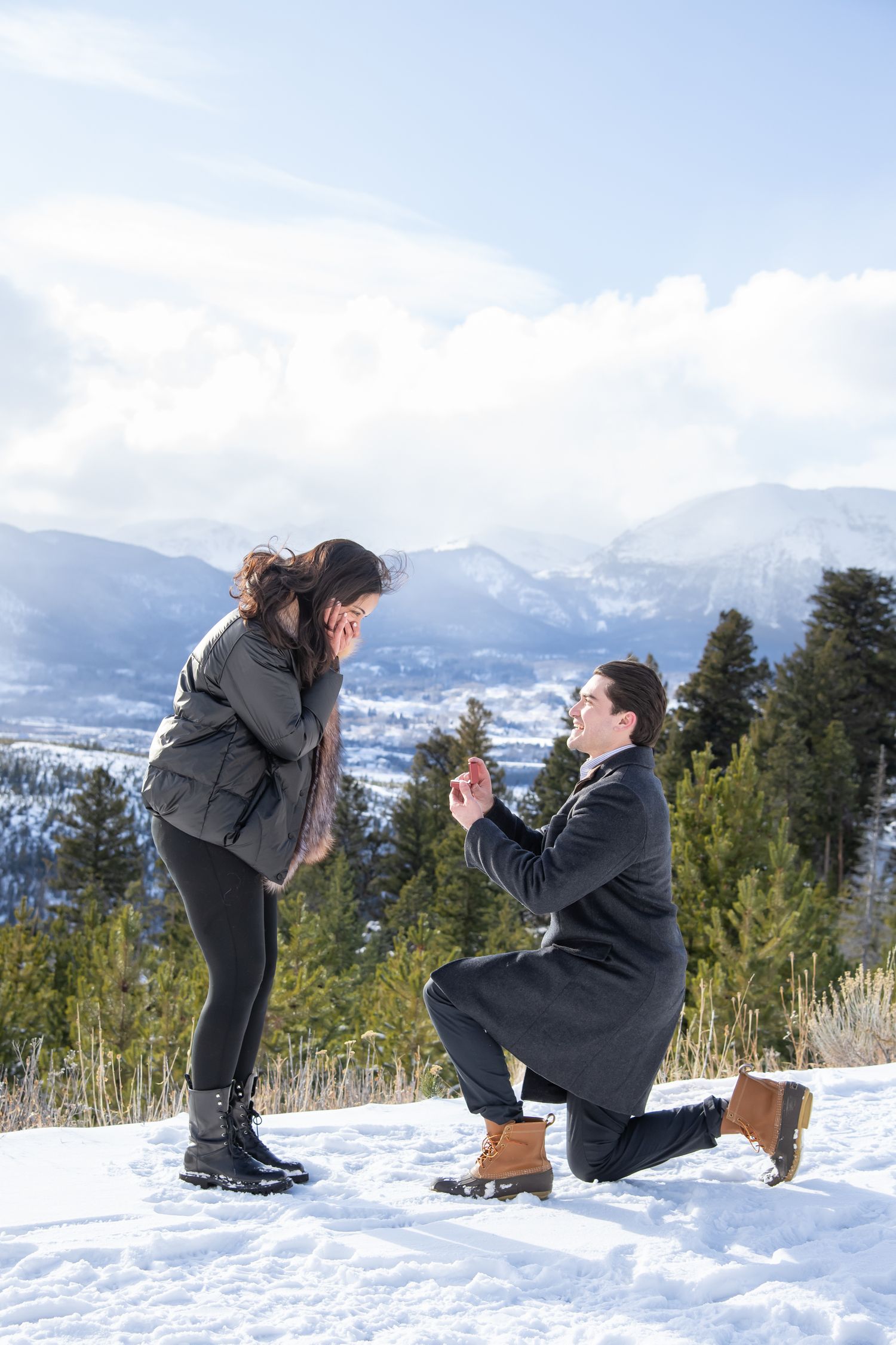 A surprise winter proposal at Sapphire Point near Breckenridge Colorado with dramatic skies and mountains.
