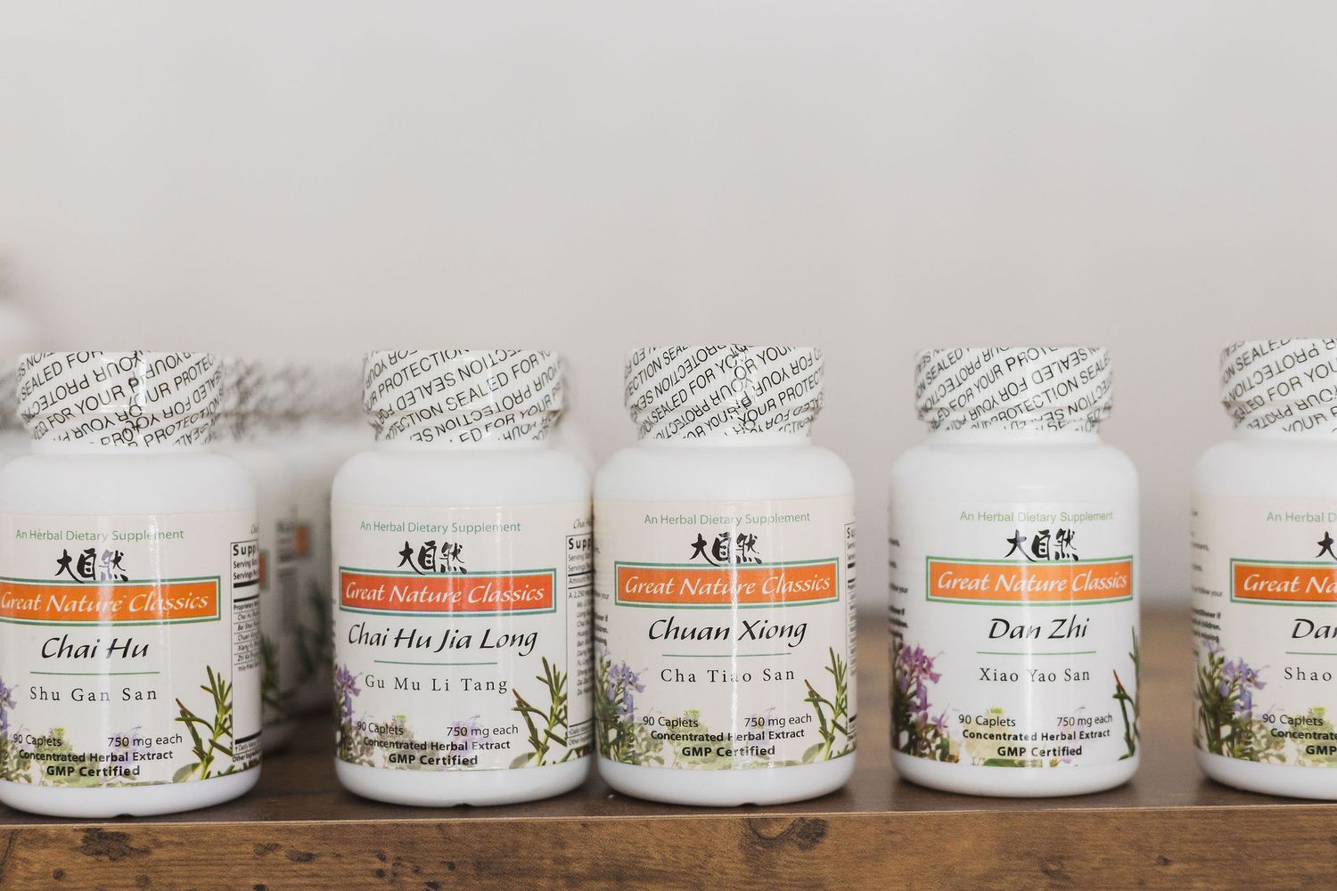 Maple Valley Acupuncture, WA branding stock photo of row of herbal supplements on shelf for acupuncture therapists to recommend to clients
