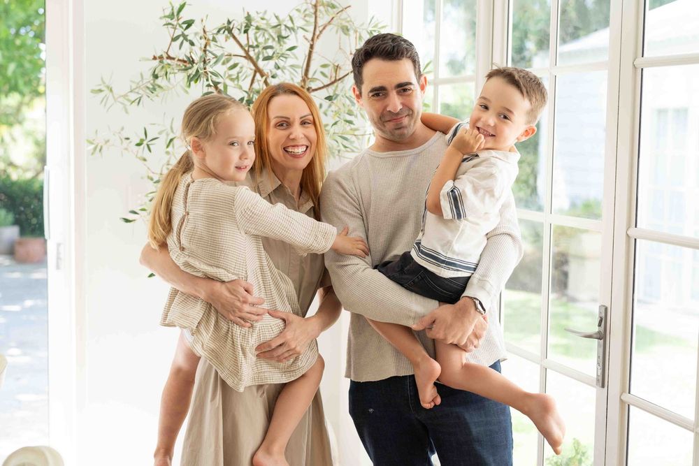 Portrait of a family with young children in mid-morning light at an indoor family photography session in Perth