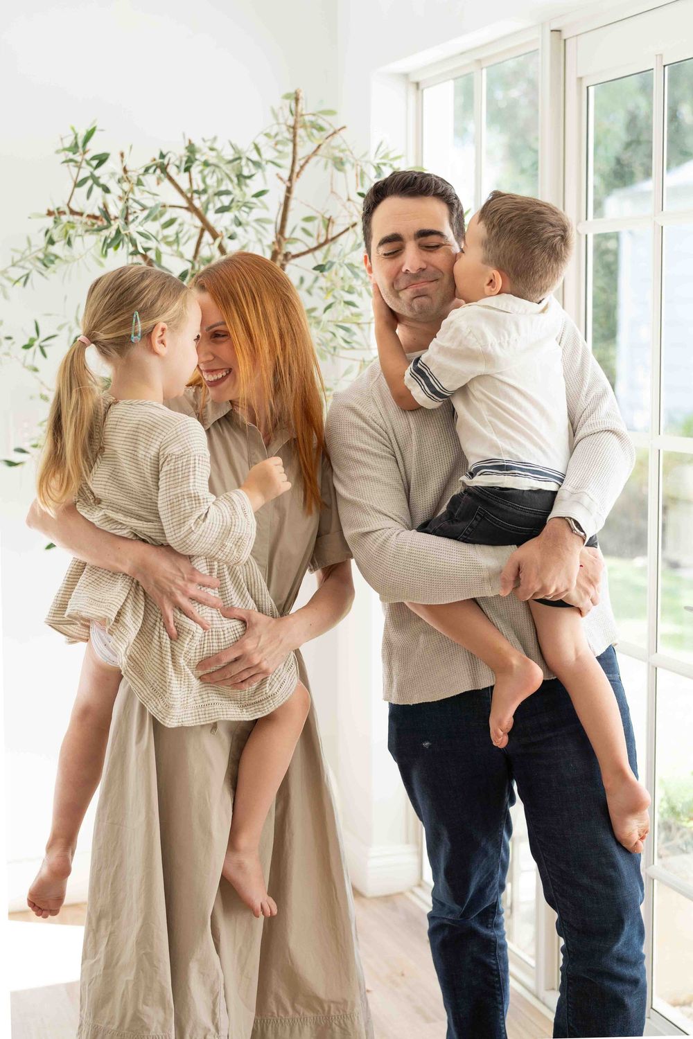 Portrait of a family with young children in mid-morning light at an indoor family photography session in Perth