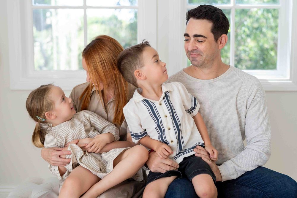 Portrait of a family with young children in mid-morning light at an indoor family photography session in Perth