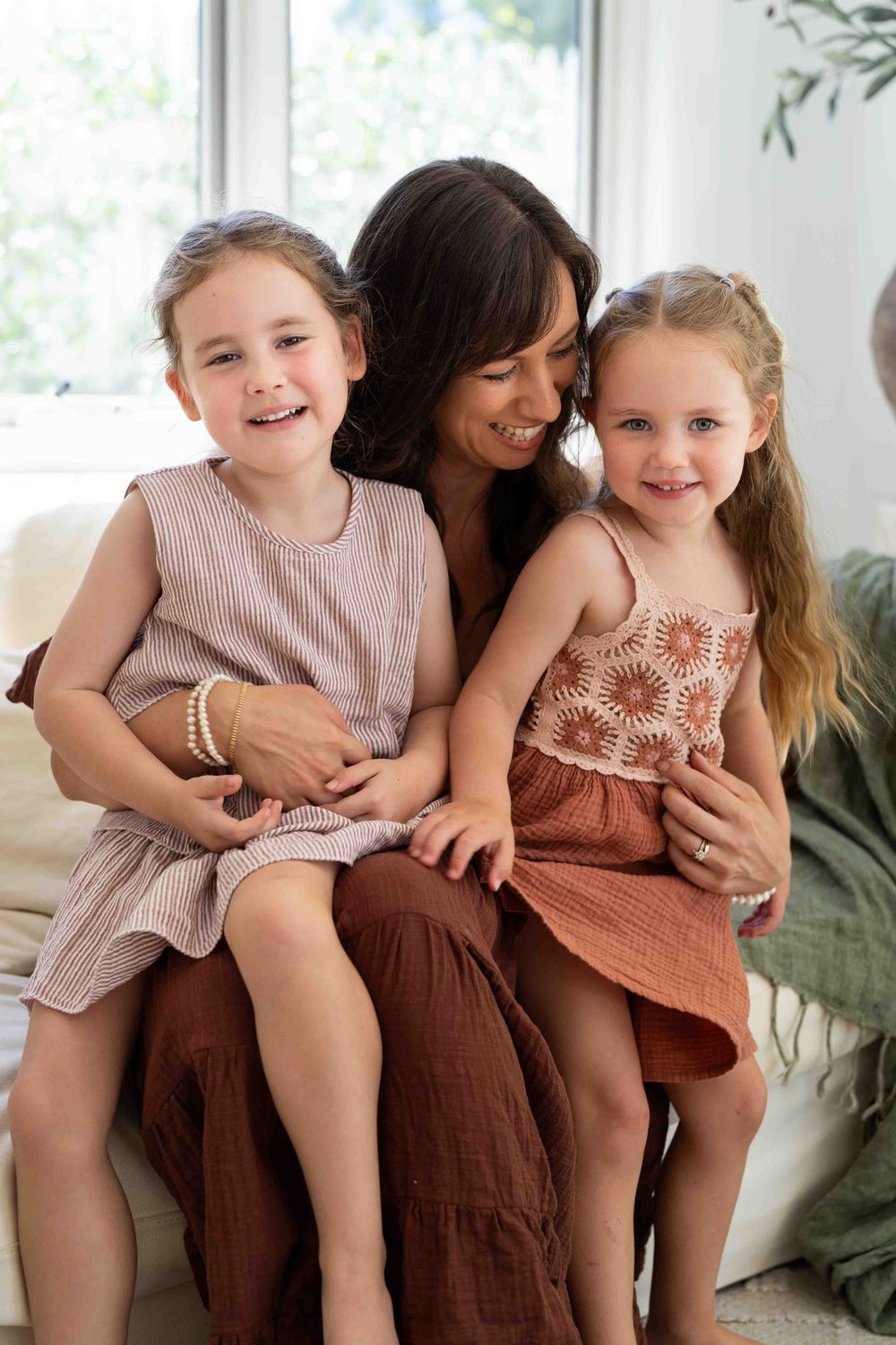 A mother holding her children during an outdoor family photography popup in Perth