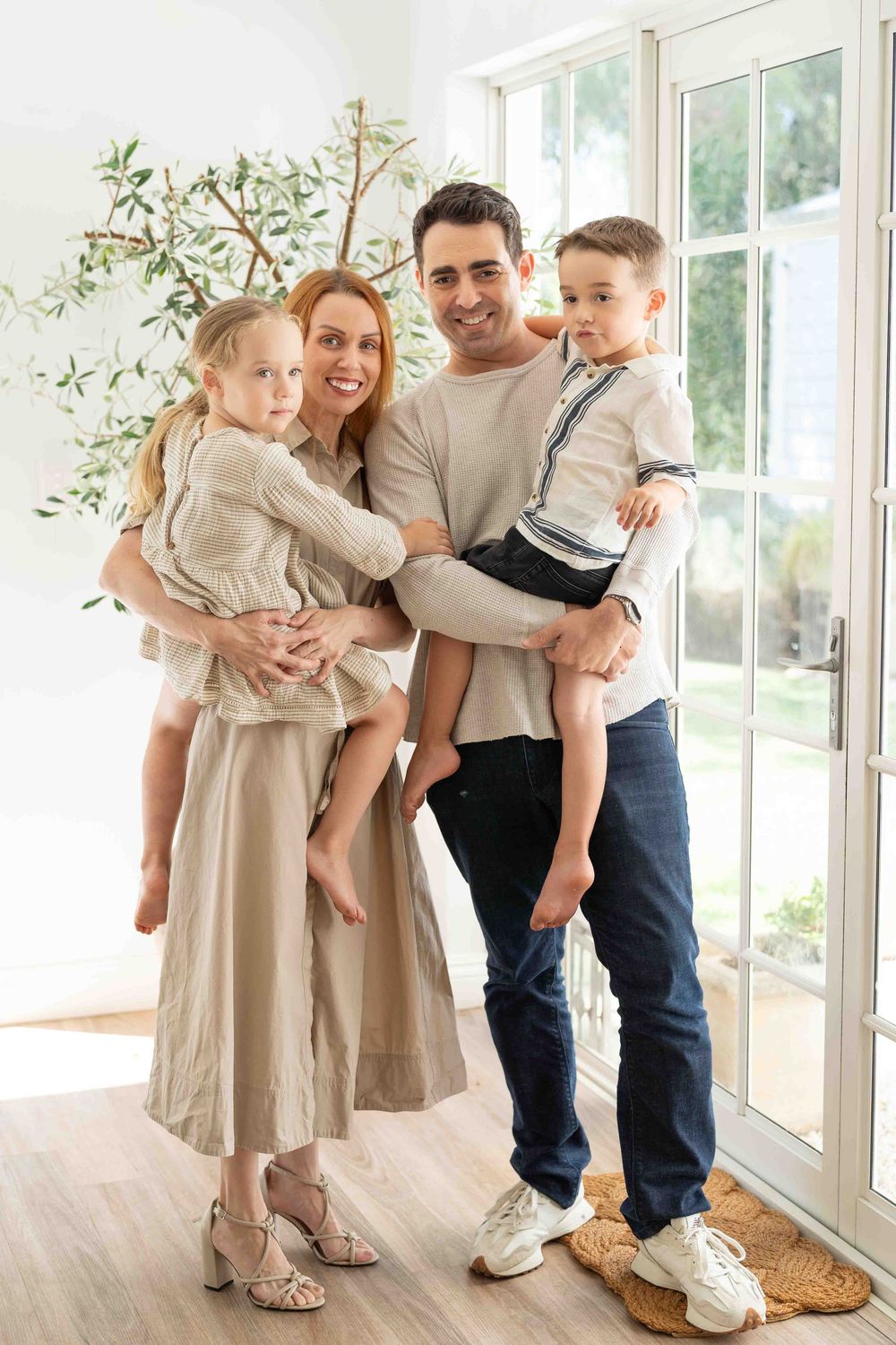 Portrait of a family with young children in mid-morning light at an indoor family photography session in Perth