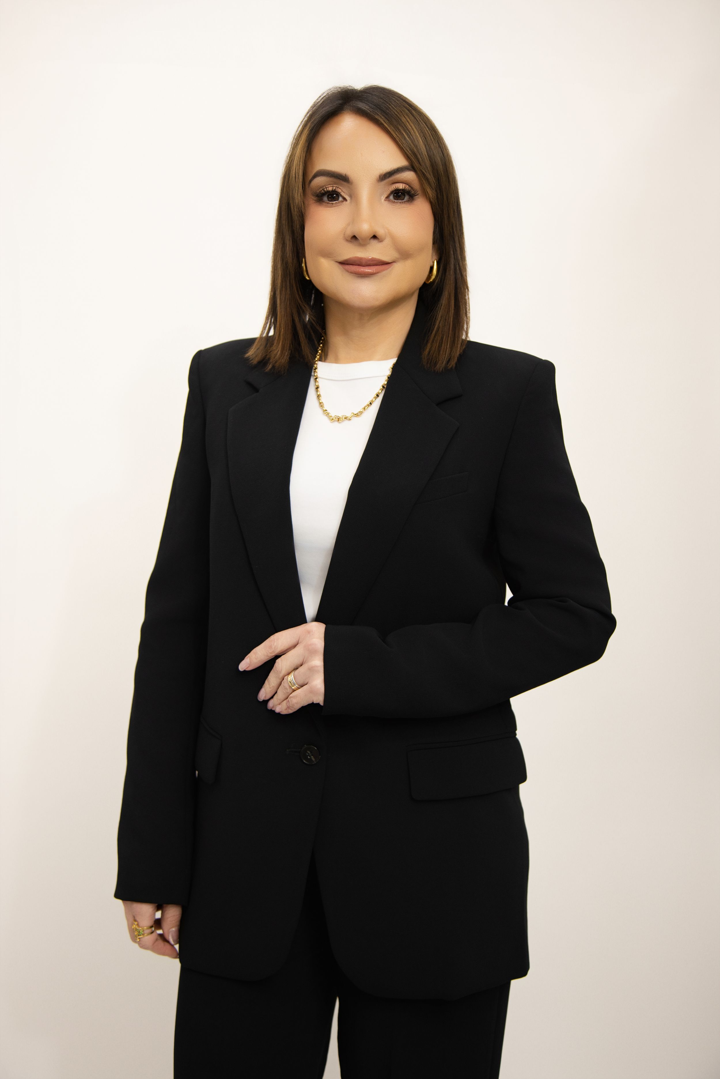 Professional portrait series showing a person in a black blazer and white top against a light background.