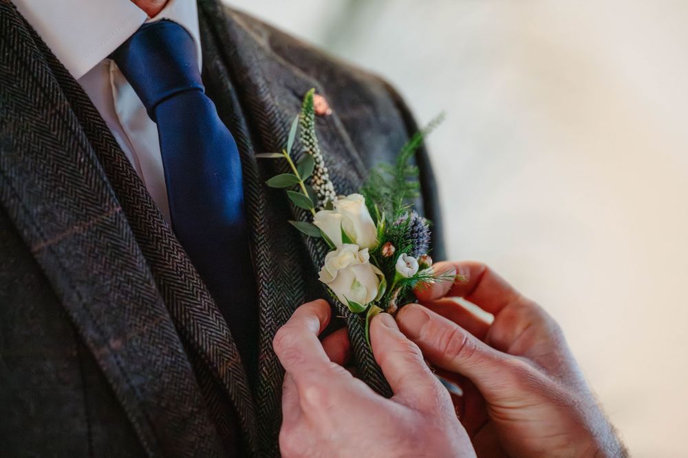 Matara Centre Wedding Photography Zara Davos Cotswolds Photographer Gloucestershire Stroud  groom having buttonhole put on