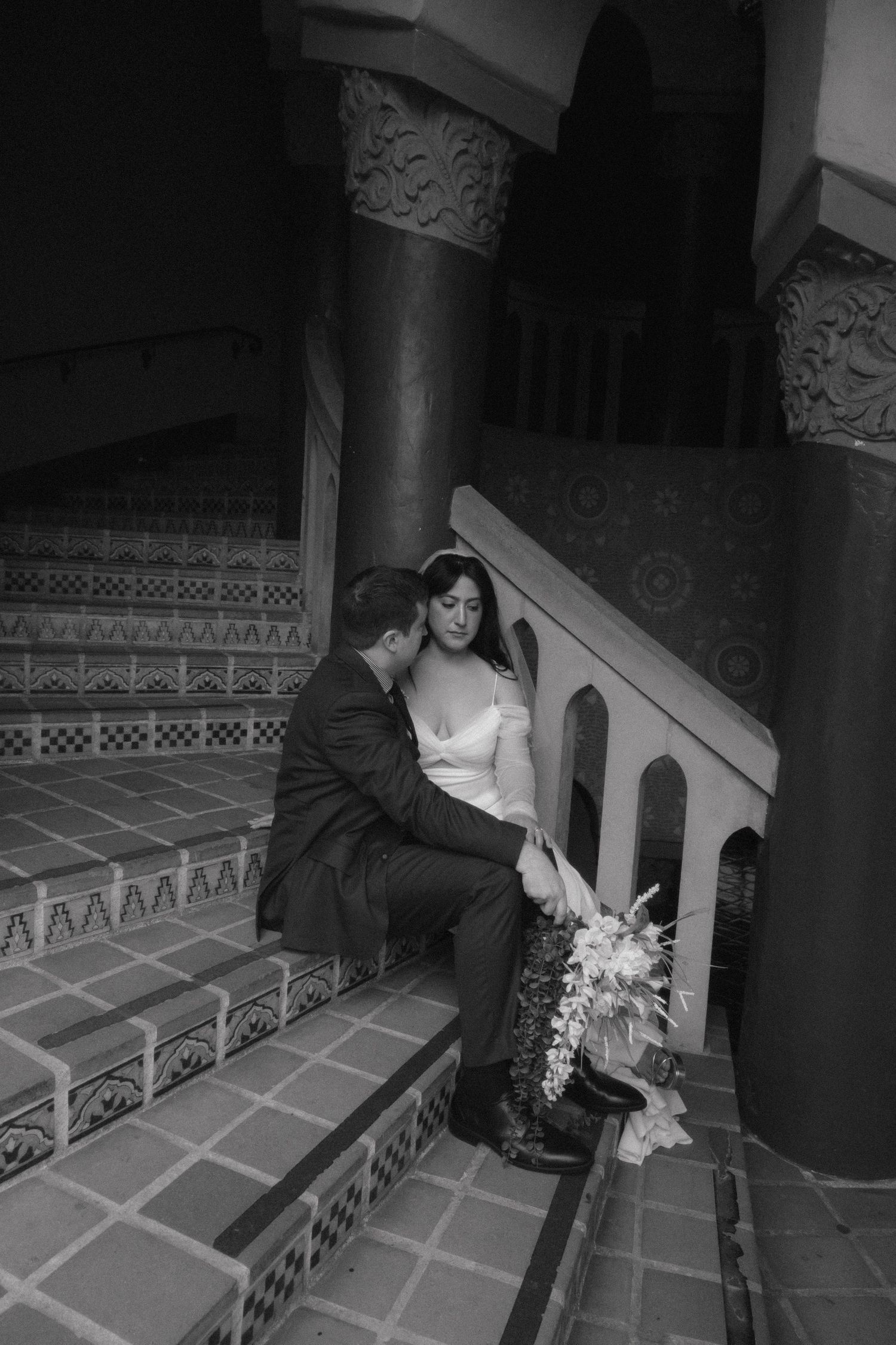 A sequence of romantic black and white photos showing a couple sitting on ornate stone steps.