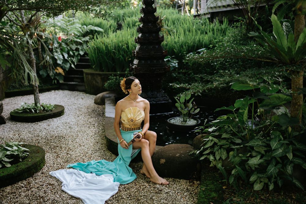 Tropical garden portrait with traditional dress and ornate landscaping.