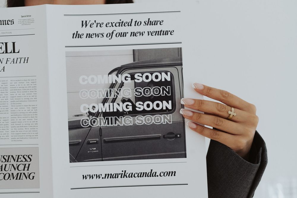 Close-up of hands holding business document with 'Coming Soon' text.