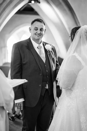A sequence of black and white wedding photos capturing interactions between a bride in white and groom in a dark suit.