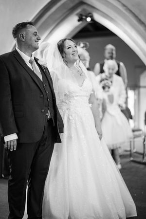 A sequence of black and white photos showing a tender moment between a bride and someone during a wedding ceremony.
