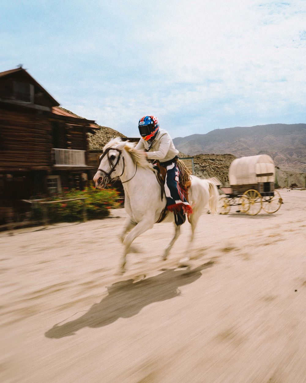 A sequence of action shots showing a horse bucking and rearing up in a dusty desert ghost town setting.