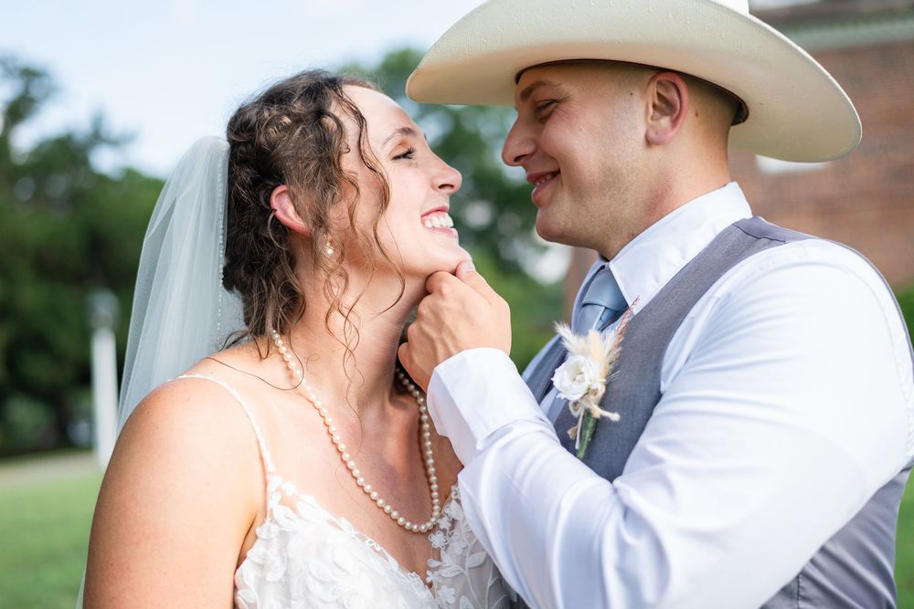 A romantic couple shares tender moments in their wedding attire during an outdoor photo session.