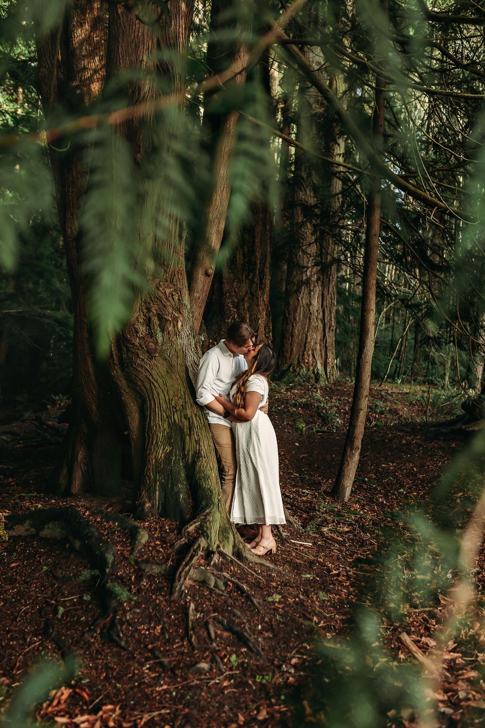 Artistic forest photoshoot with natural lighting filtering through dense foliage.