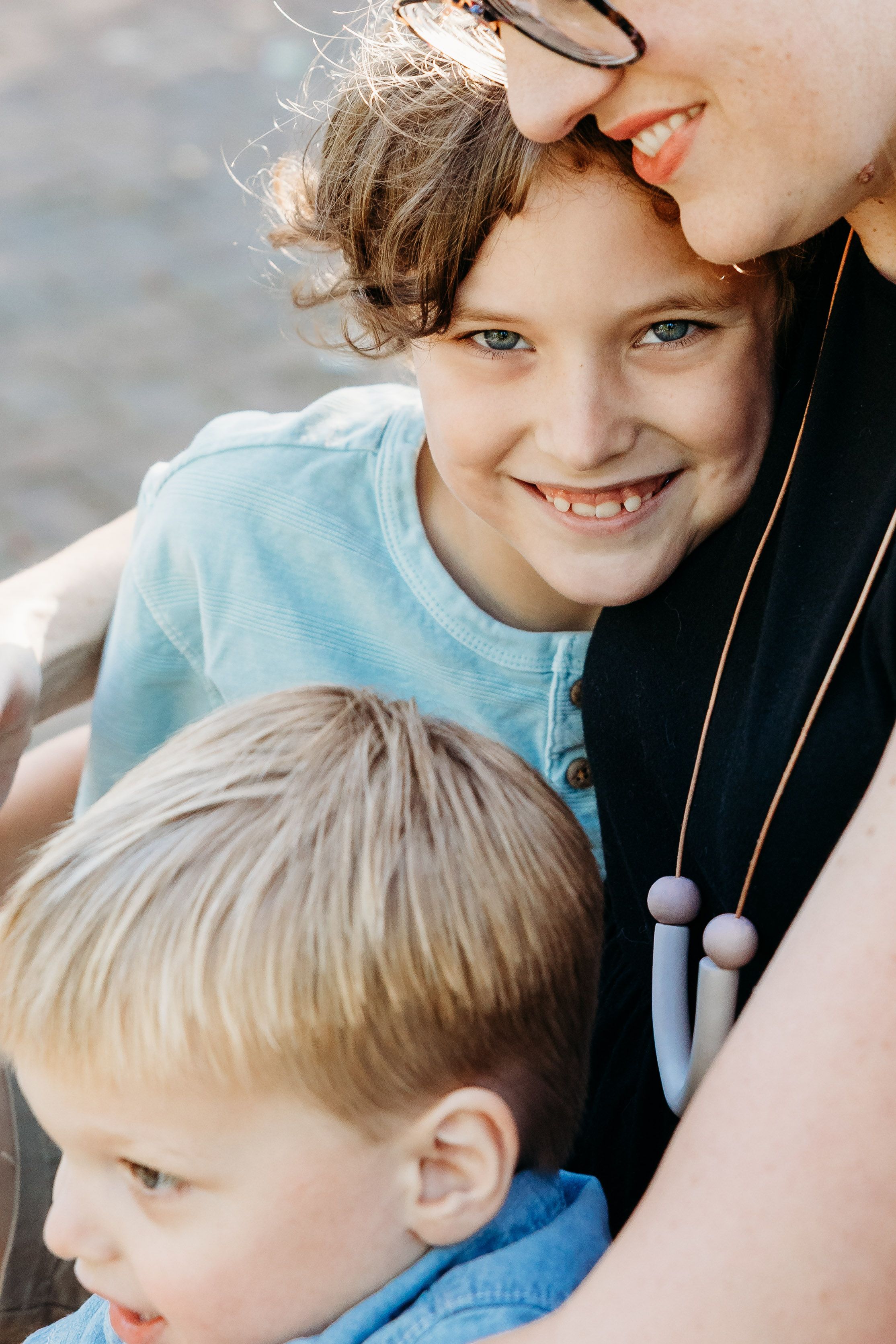 Close up shots of joyful interactions and candid smiling moments captured during an outdoor photo session.