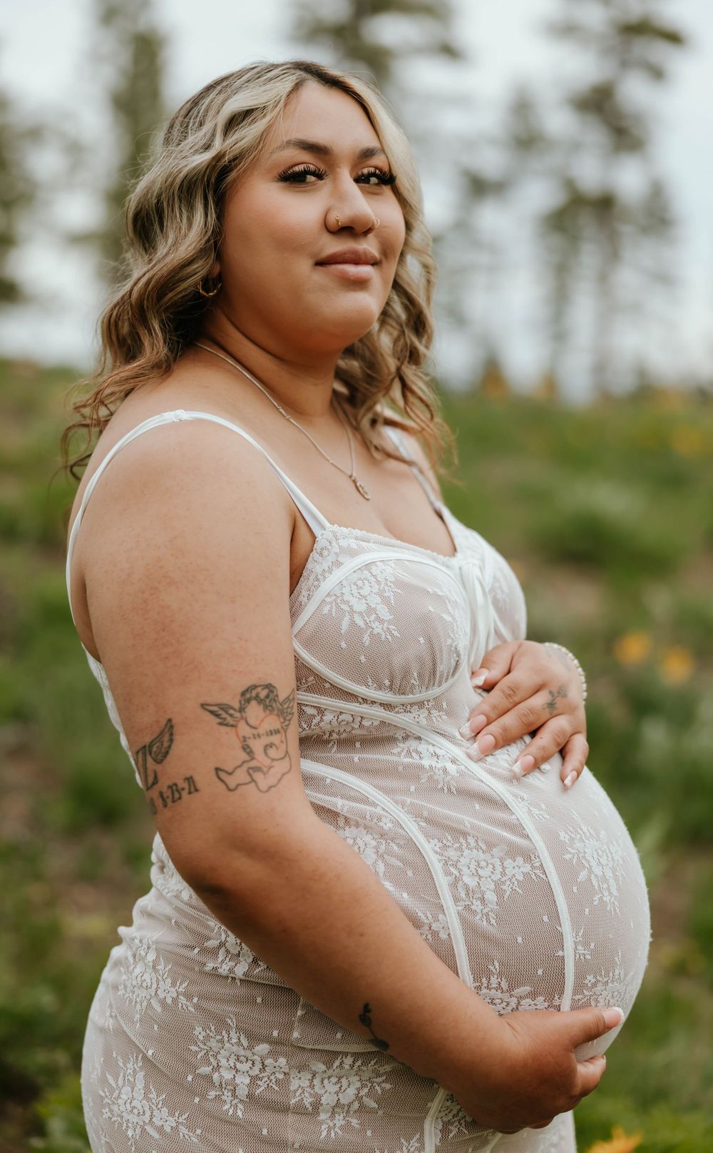 Side view of maternity dress with lace details in outdoor setting.