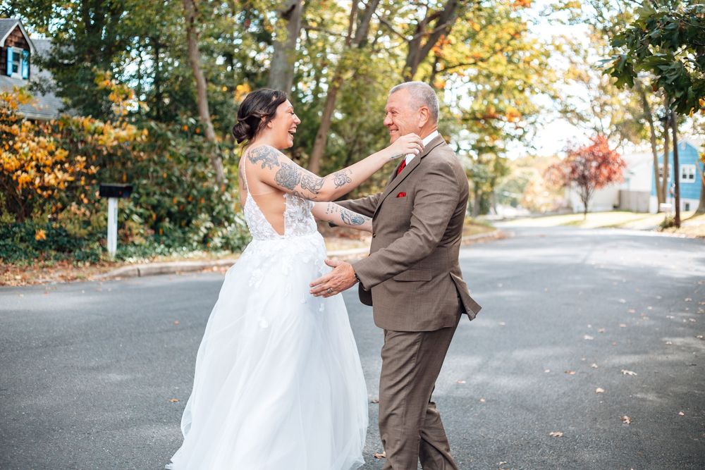 Wedding couple sharing intimate moments in a sunny outdoor autumn setting.