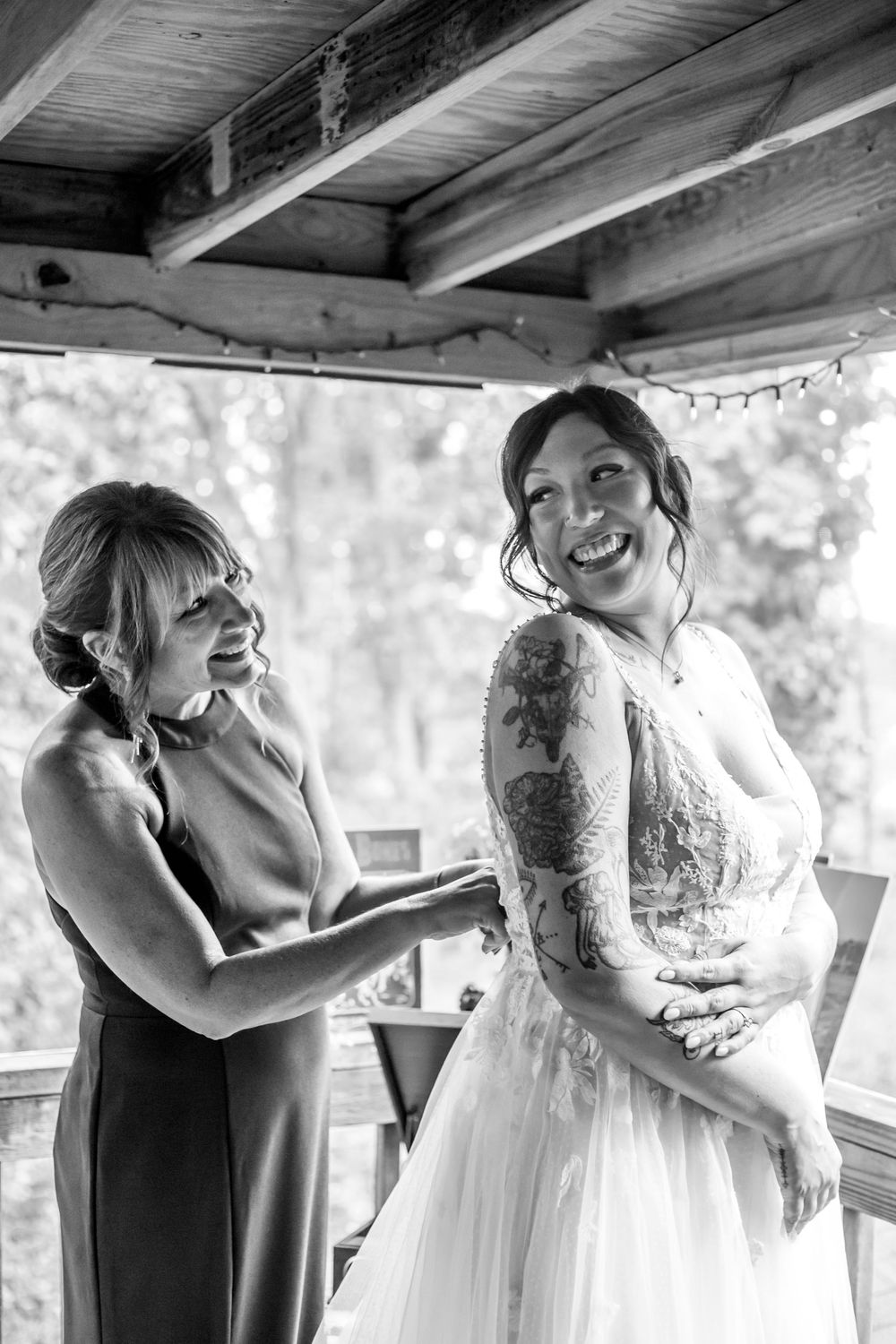A series of candid emotional moments showing wedding party members embracing in a rustic venue setting.