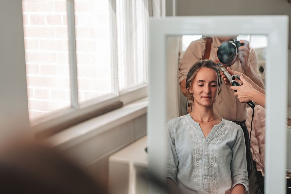A bright bedroom scene with light filtering through sheer curtains creating a warm, intimate atmosphere.