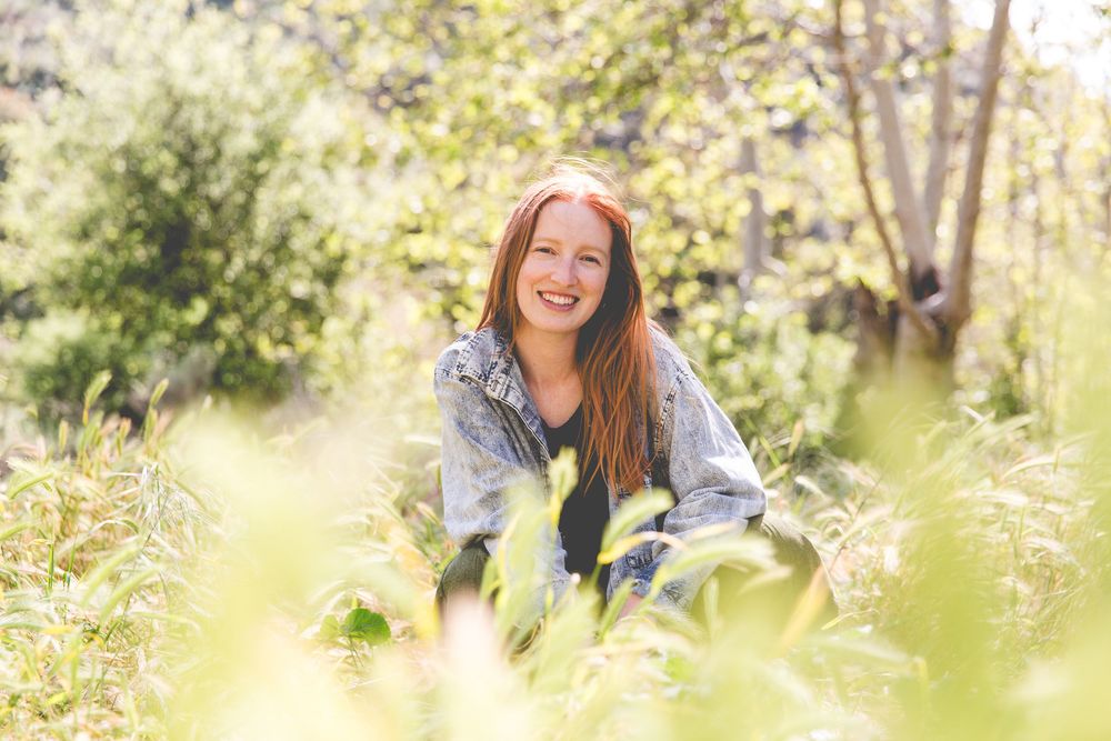 Candid outdoor photo session among tall grasses and natural scenery.