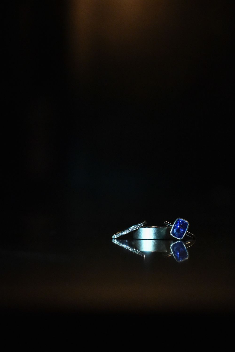 A moving LED light creates a blue glowing trail effect against a dark background in three sequential images.