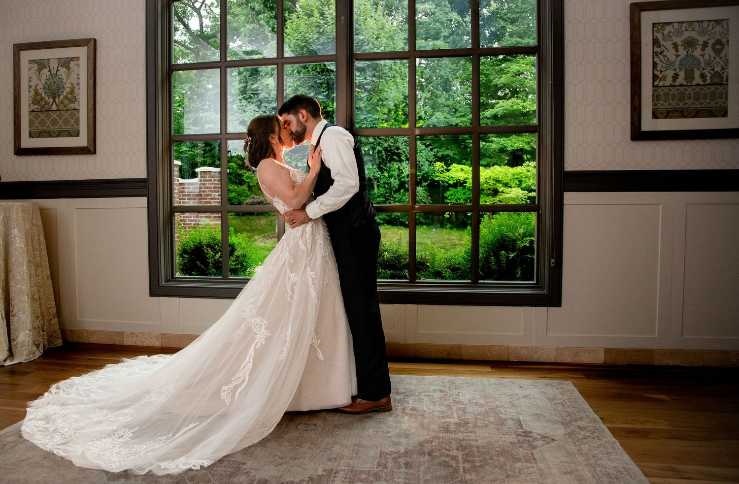 Bride and groom kissing by window Bride and groom in rain at 2gather more wedding venue in michigan