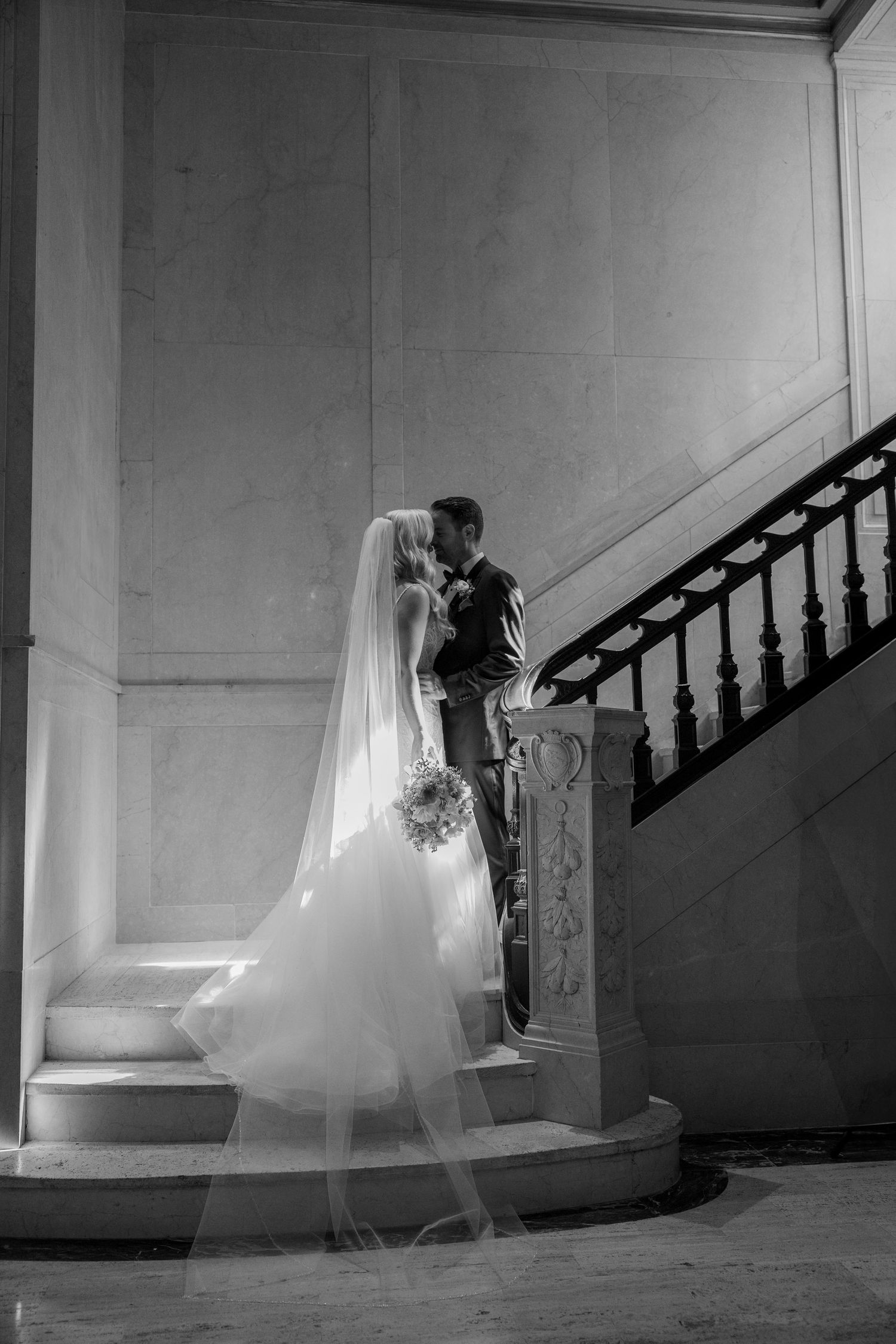 Bride and Groom kissing at staircase Black and white picture at the book tower in Detroit Michigan