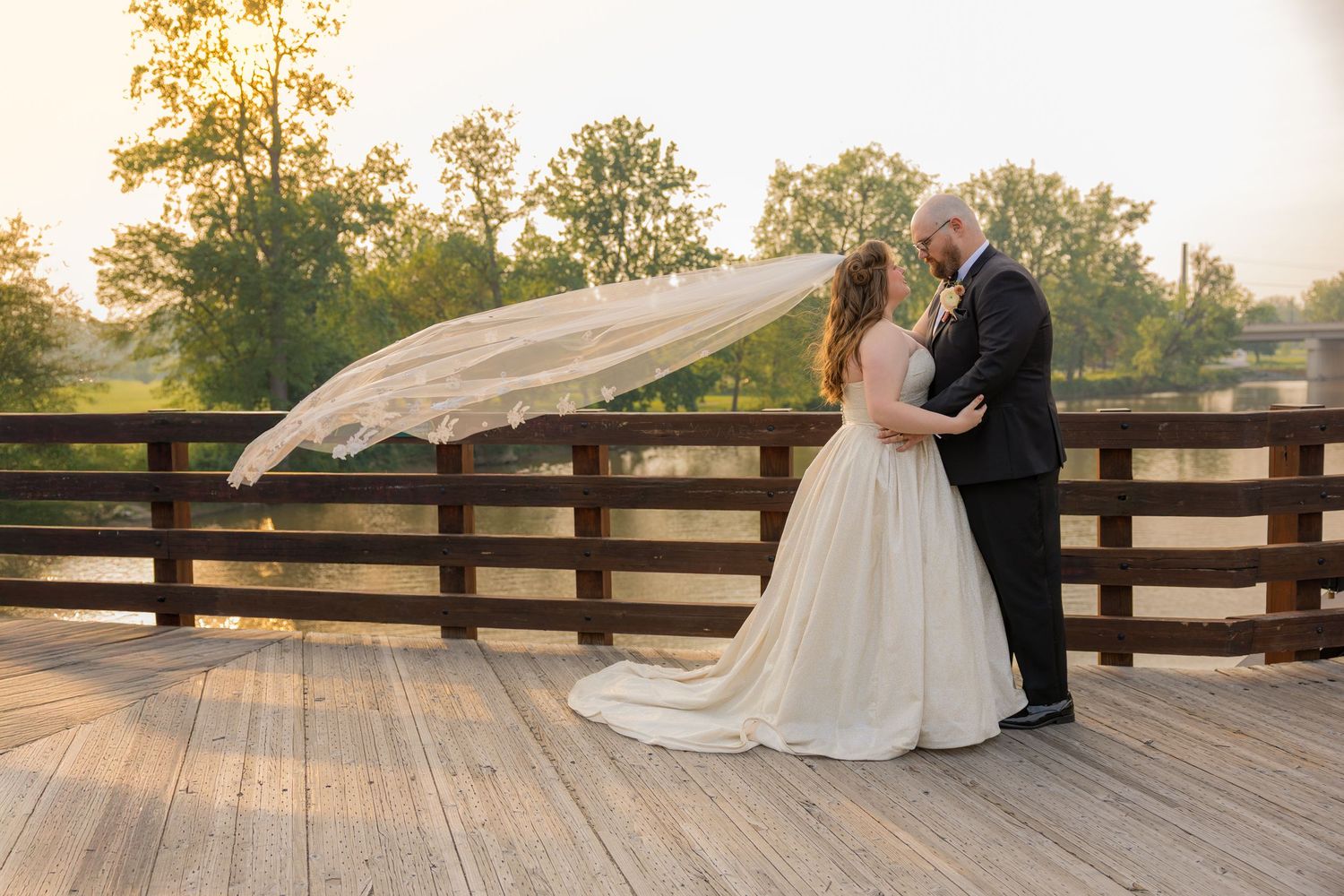 Bride and groom embracing and veil sweeping in the air at bride in midtown Michigan