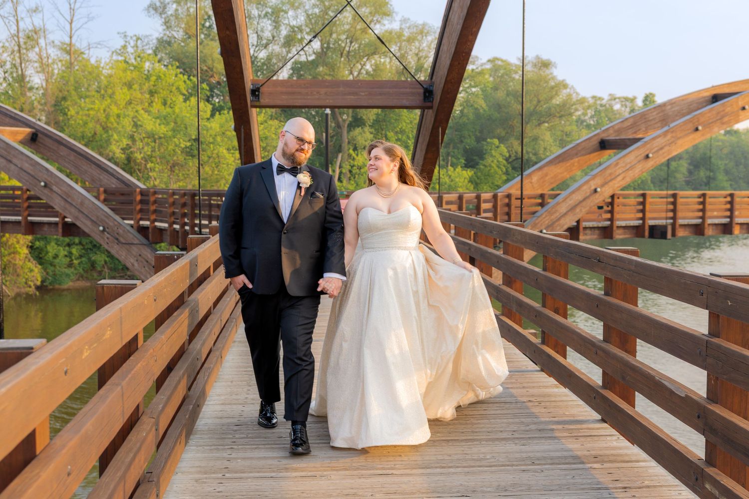 Bride and groom on bridge in midtown Michigan
