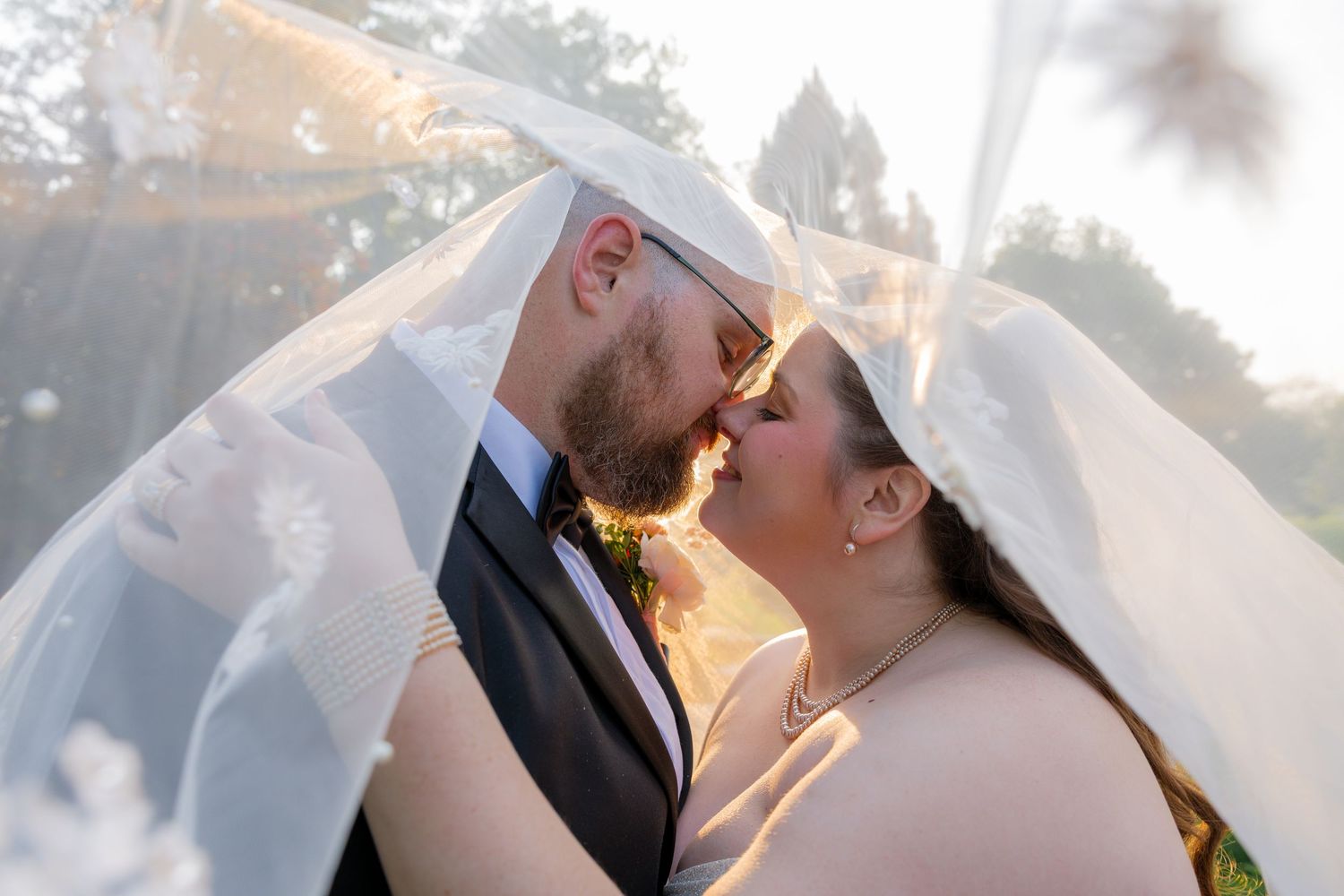 bride and groom veil shot