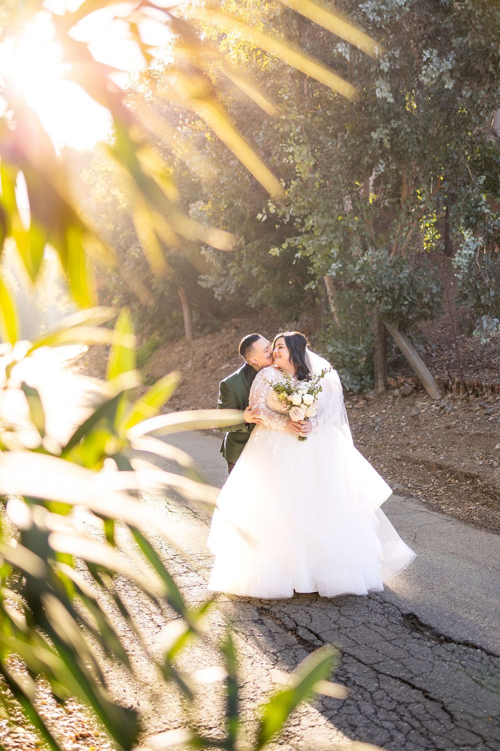 Newlywed couple shares intimate moments on a sunlit garden path through three romantic wedding photographs.
