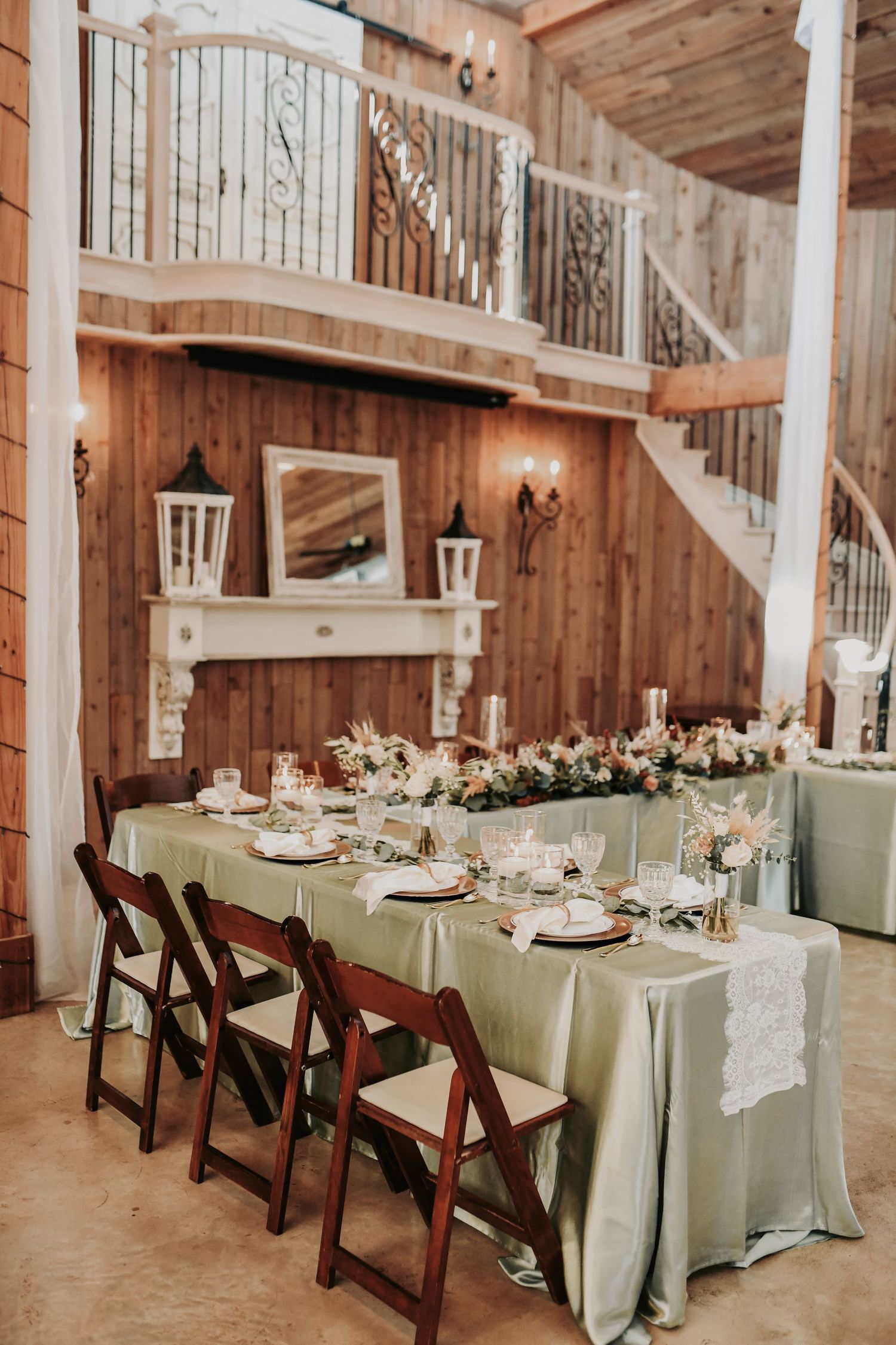 Elegant boho-inspired wedding décor with greenery runners and glowing candlelight at whispering oaks