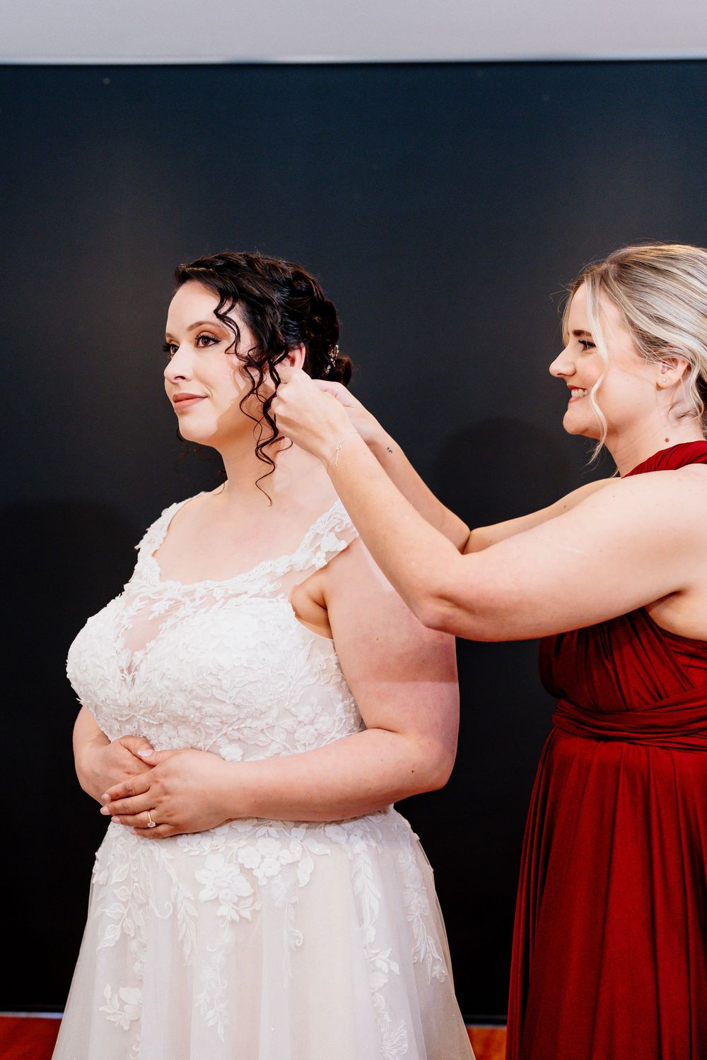 A series of candid moments showing someone in a white wedding dress being assisted by a person in red attire.
