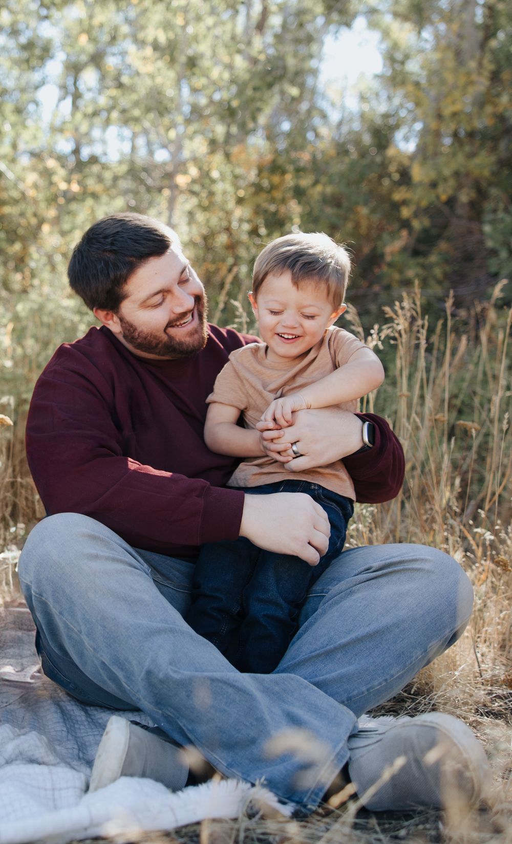 Candid moments of parent and child playing during outdoor photo session.