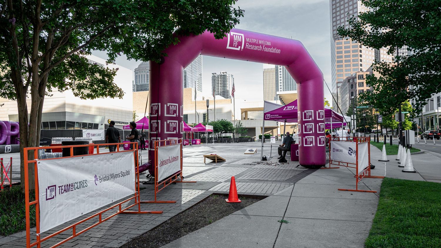 Pink inflatable arch marks the start of a Multiple Myeloma Research Foundation charity walk event outdoors.