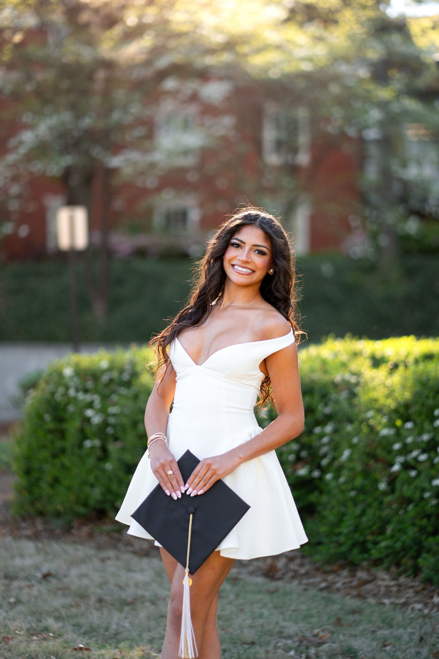 Smiling graduate poses for the best Atlanta grad photos at Georgia Tech