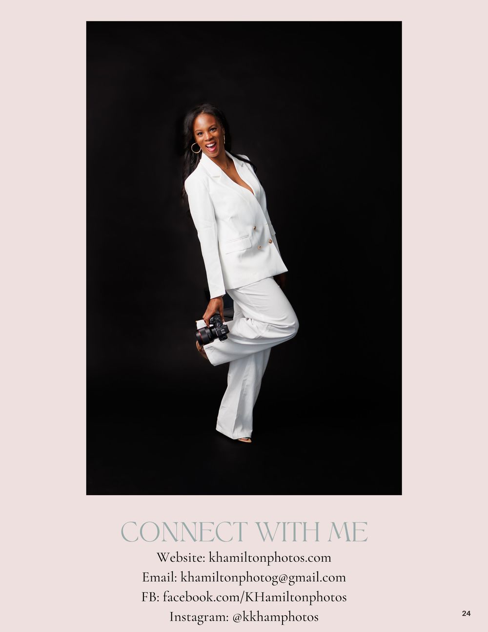 Woman in white suit posing confidently against dark background, holding camera, promoting KHamilton Photos photography services.