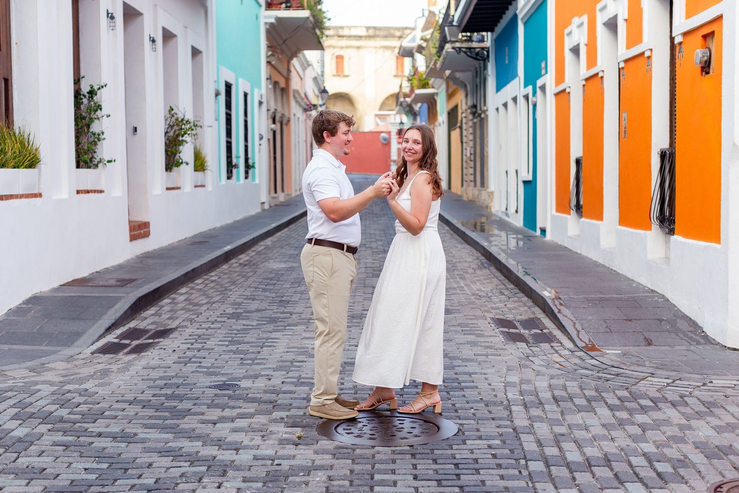 Couples portrait in the middle of the street. Engagement photo session in Old San Juan, Puerto Rico.