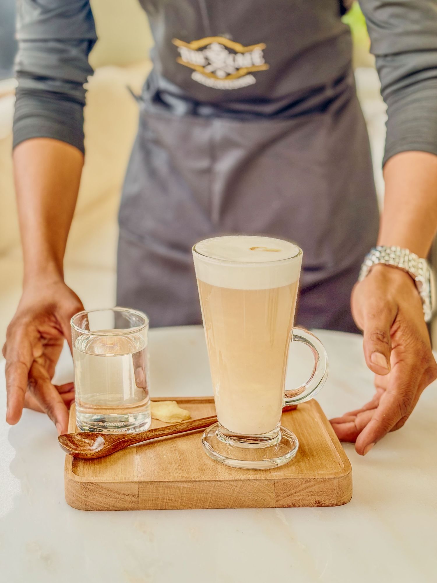 coffee service
Lodge staff serving a tall iced coffee drink on a wooden tray — hospitality detail photography by Shan Theisinger, Namibia