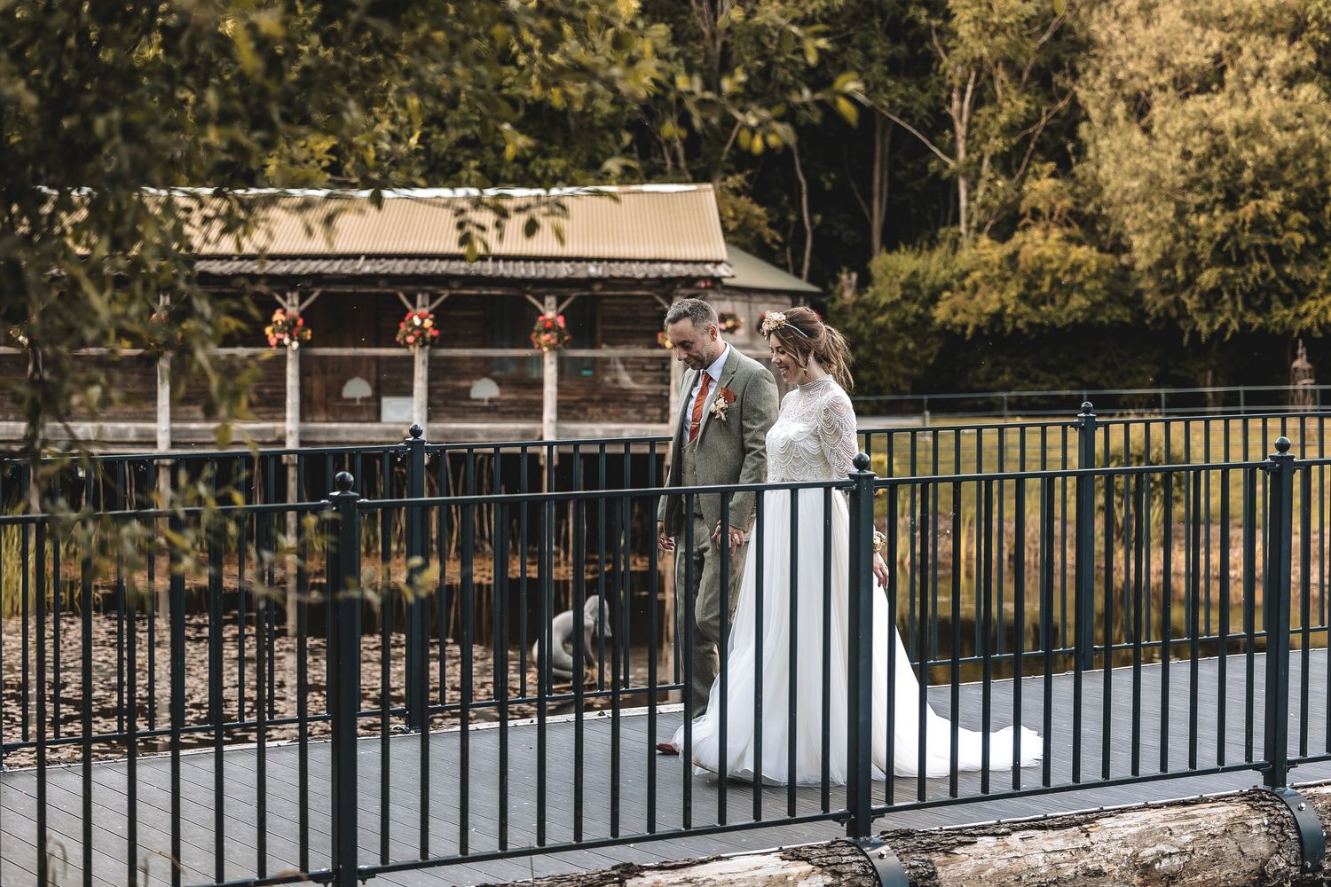 Relaxed couple walking through woodland wedding venue in Yorkshire.
