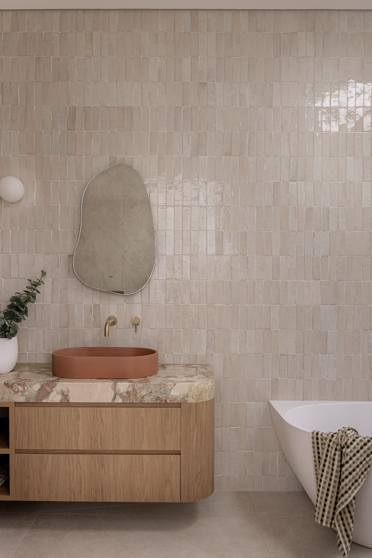 Bathroom interior photography showcasing natural stone, warm tones and refined finishes in Miranda NSW.