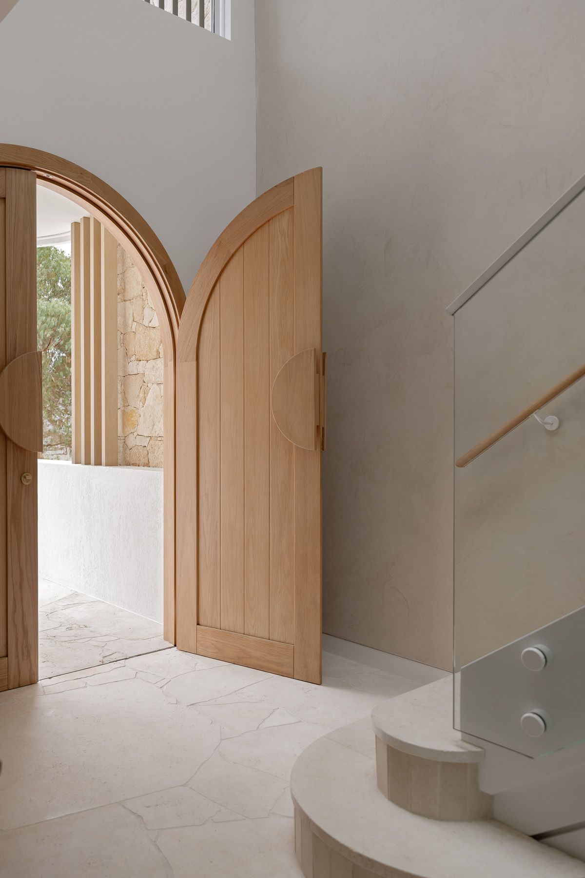 Architectural interior photography of curved entryway and staircase detail in luxury Miranda duplex, Sutherland Shire NSW.